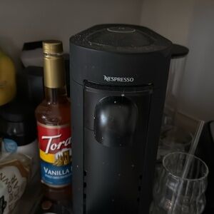 Nespresso coffee maker. Needs cleaning and different flavor pods come with it